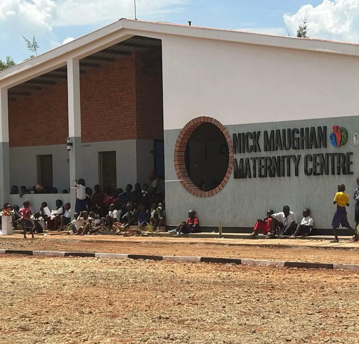 The Nick Maughan Maternity Centre in Mbale, with people gathered outside